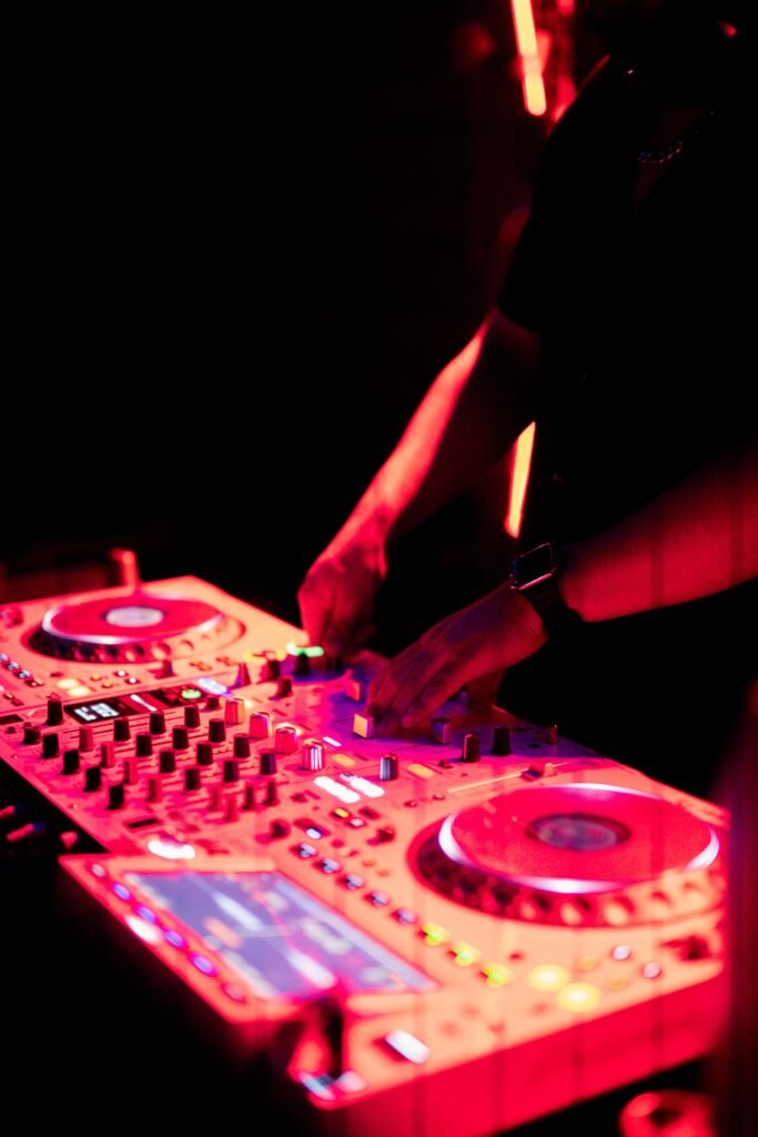 DJ hands on a sound mixer on stage