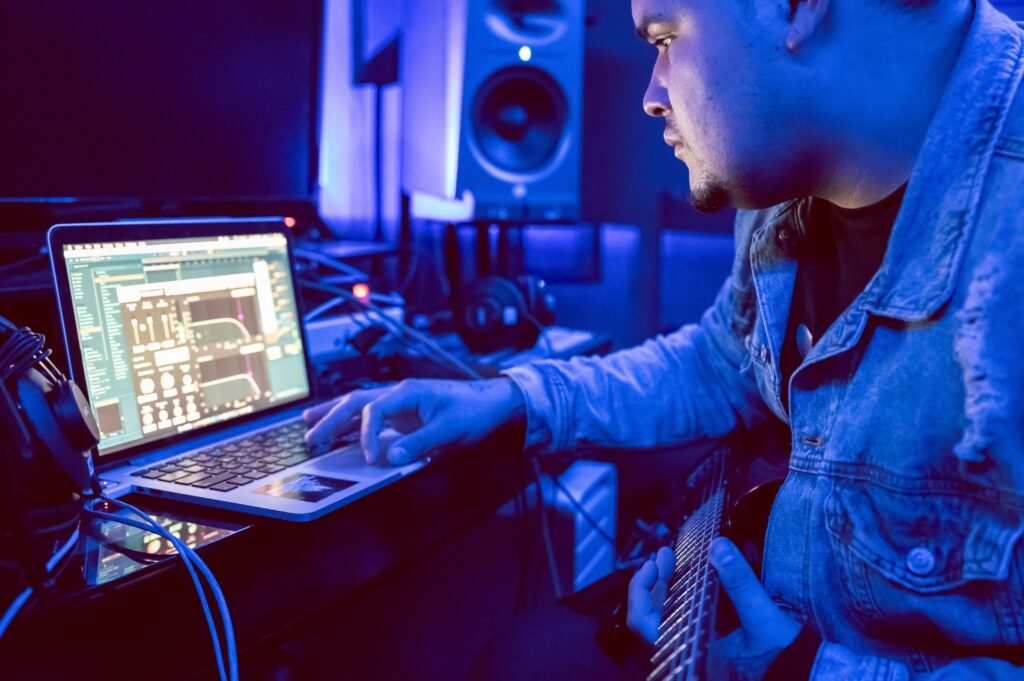 Music producer working on a laptop in the studio